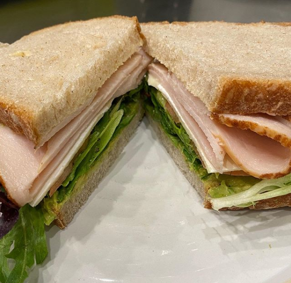 A sandwich cut in half on top of a plate.